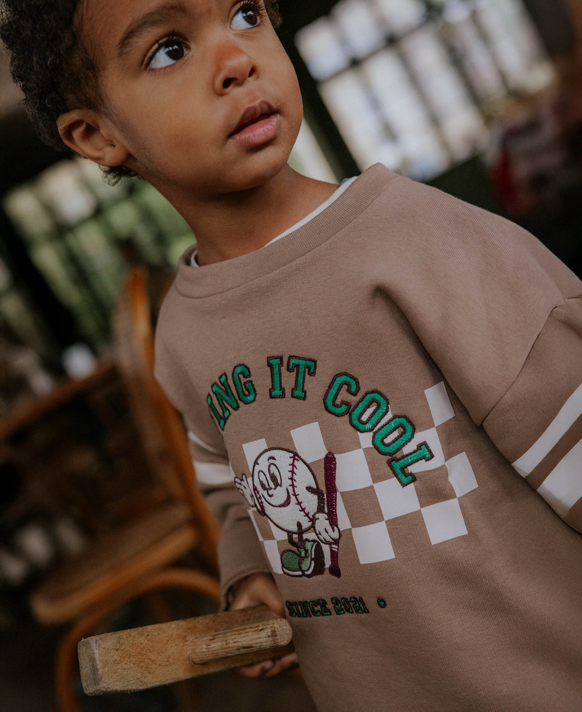 Close-up of the 'Playing it cool' checkerboard print on the Alvin sweatshirt
