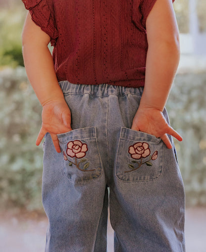 Close-up of the embroidered rose back pockets on the Don Rose Pant