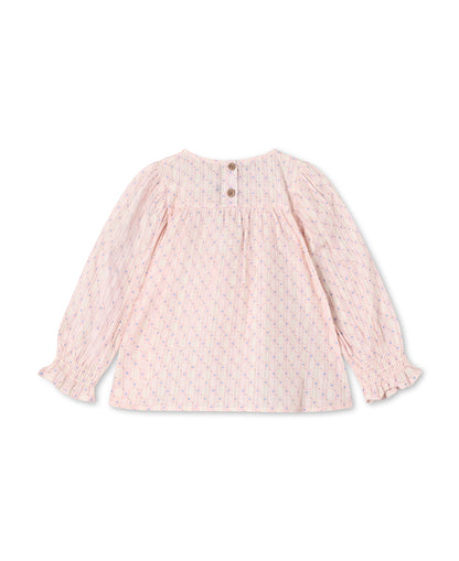 Back of the chalk pink blouse, showing the button fastening at the neck